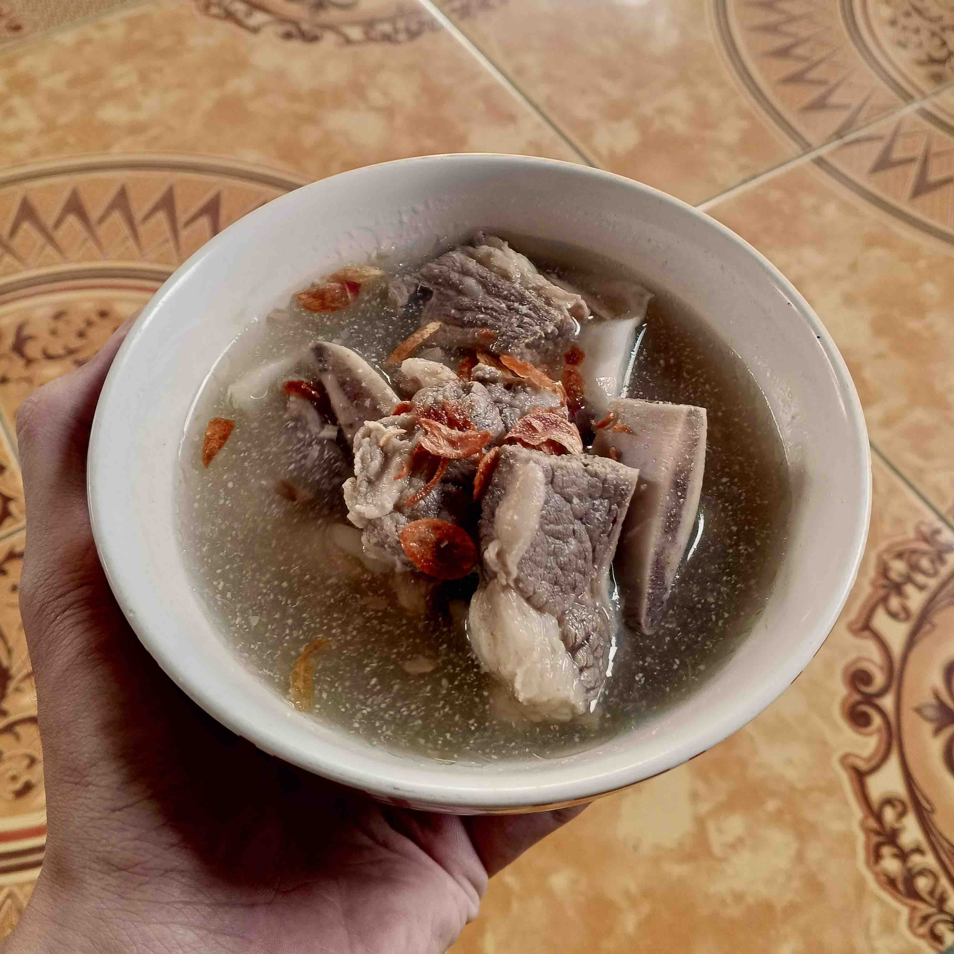 Sop iga served in a white ceramic bowl