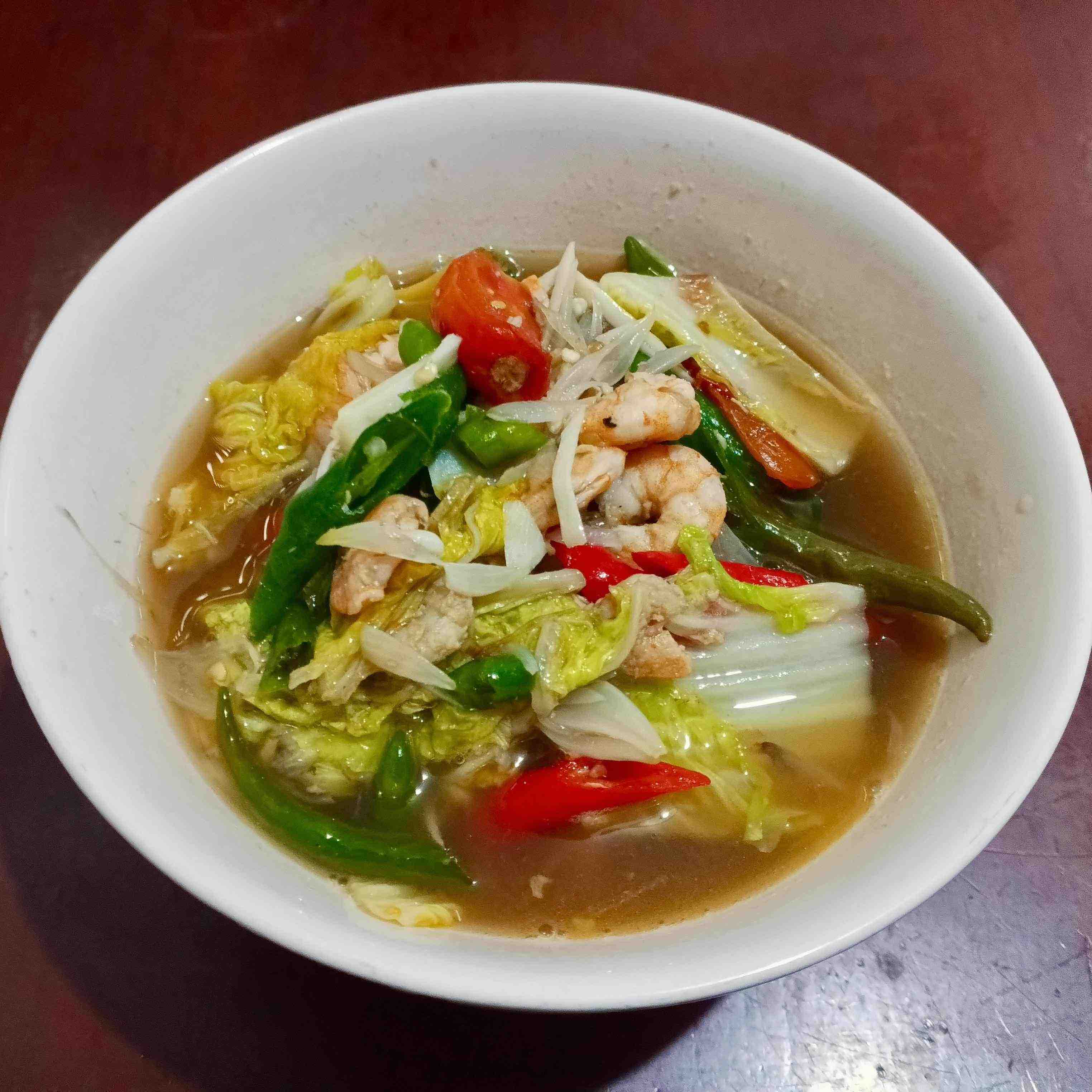 Tumis sawi udang served in a white melamine bowl